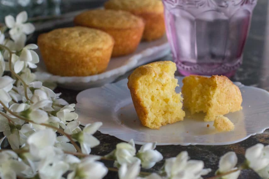 Low FODMAP corn muffin - perfectly moist, slightly sweet, and with the perfect crumble - cut open on a plate.