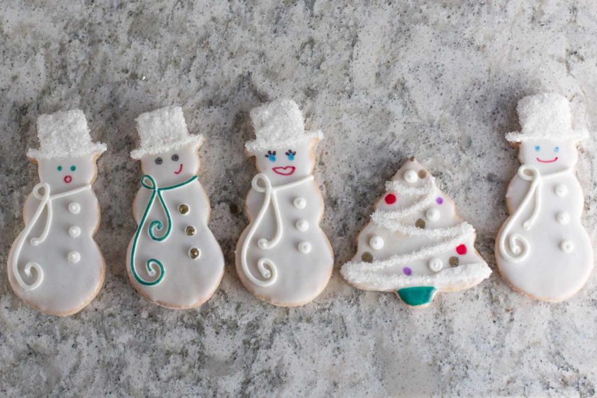 overhead of decorated sugar cookies with edible pen details