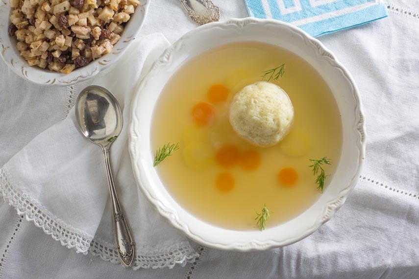 https://www.fodmapeveryday.com/wp-content/uploads/2018/02/Matzo-ball-soup-in-a-white-bowl-with-charoset-in-the-background.jpg