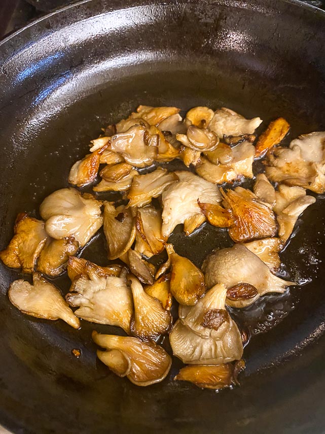 sauteeing oyster mushrooms until they begin to crisp around the edges