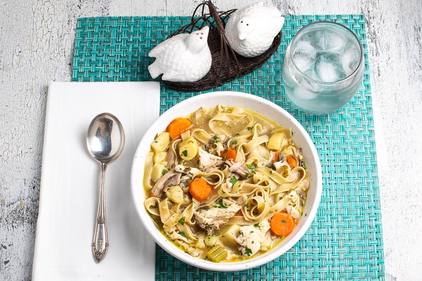 https://www.fodmapeveryday.com/wp-content/uploads/2020/11/low-FODMAP-Instant-Pot-Chicken-Noodle-Soup-in-a-white-bowl-on-an-aqua-placemat-with-a-water-glass.jpg