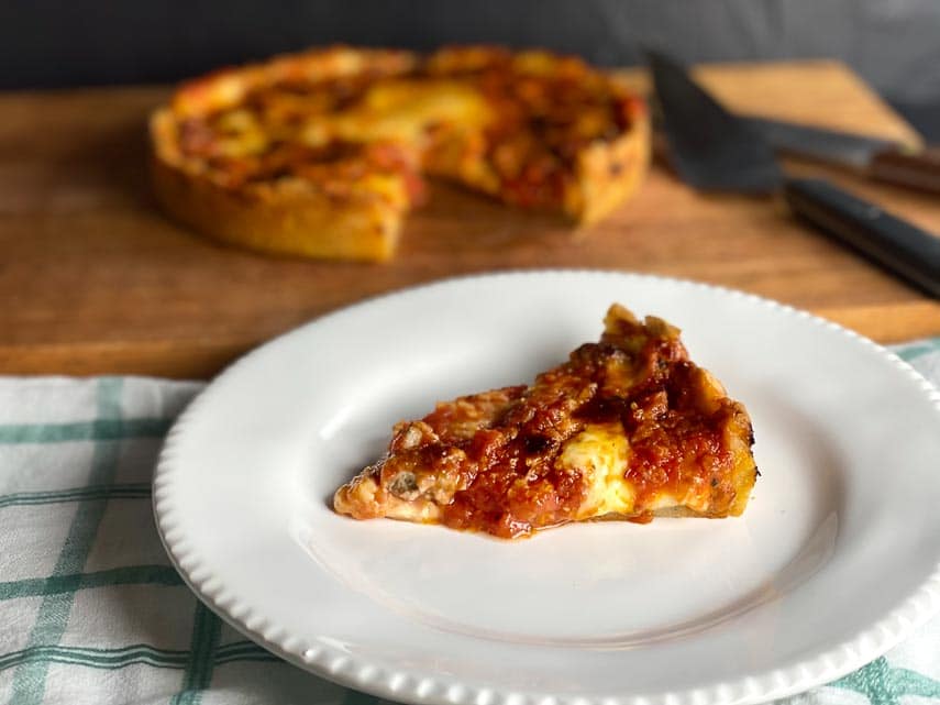 https://www.fodmapeveryday.com/wp-content/uploads/2021/03/deep-dish-low-FODMAP-pizza-on-board-wedge-cut-out-wedge-on-white-plate.jpg