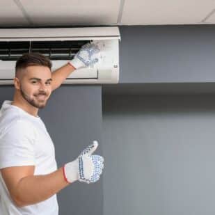man fixing an air conditioning unit / air conditioner
