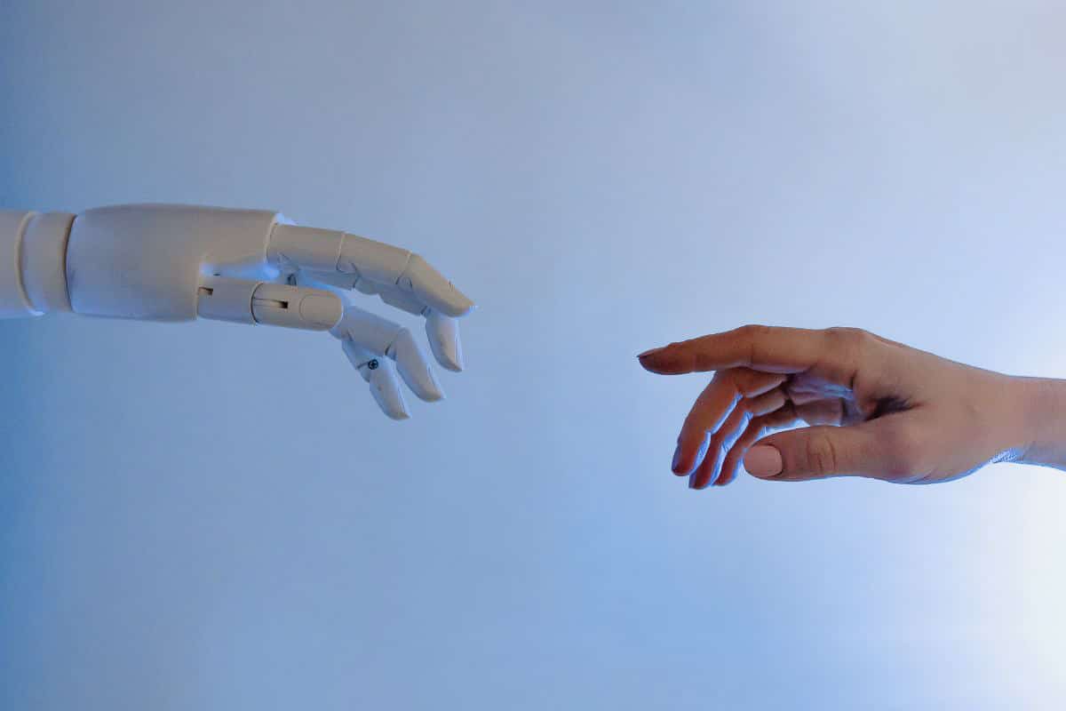 robot hand reaching for human hand.