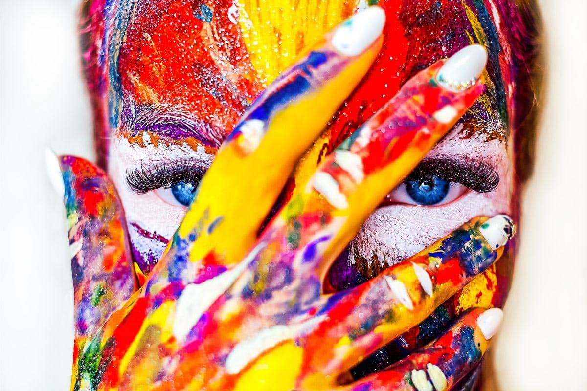 woman with colored paint on face.