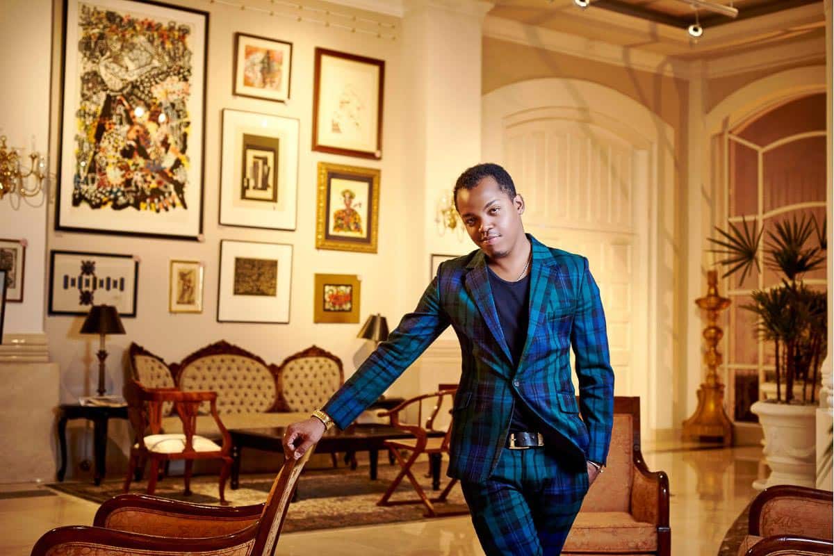 Man in blue plaid suit in living room.