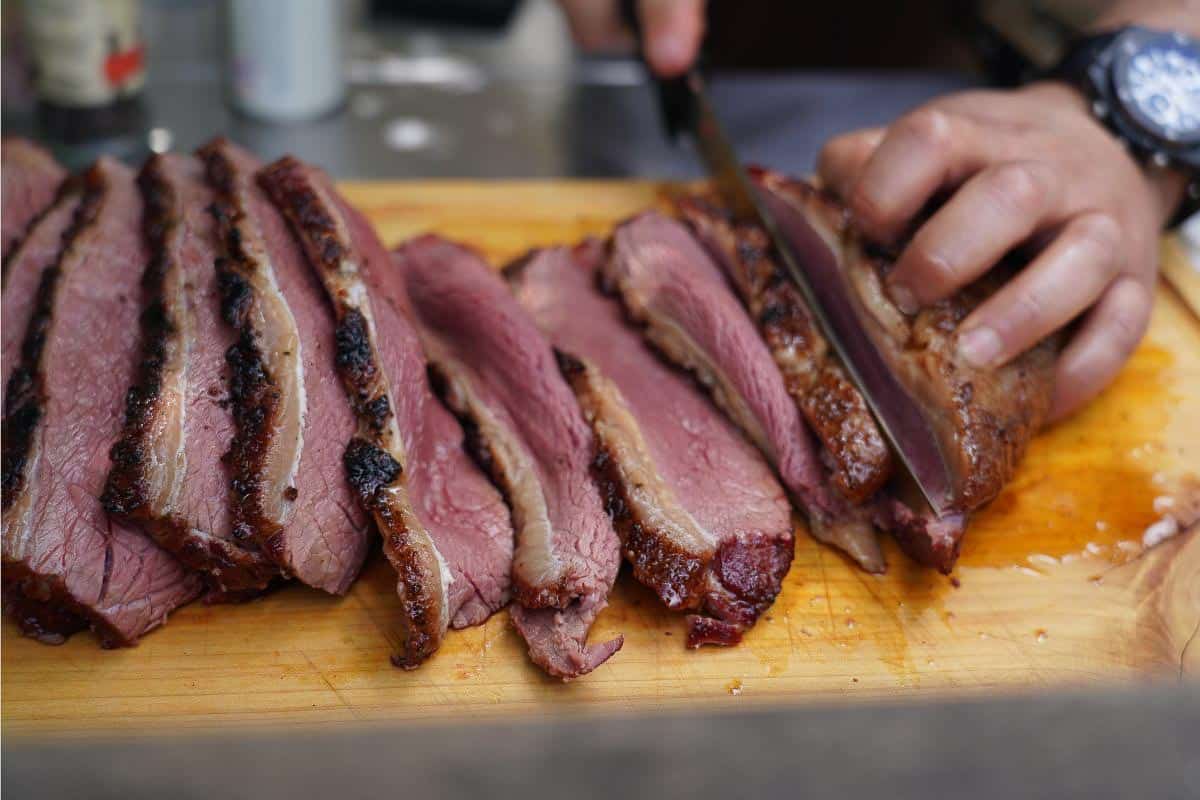 Man slicing steak. 