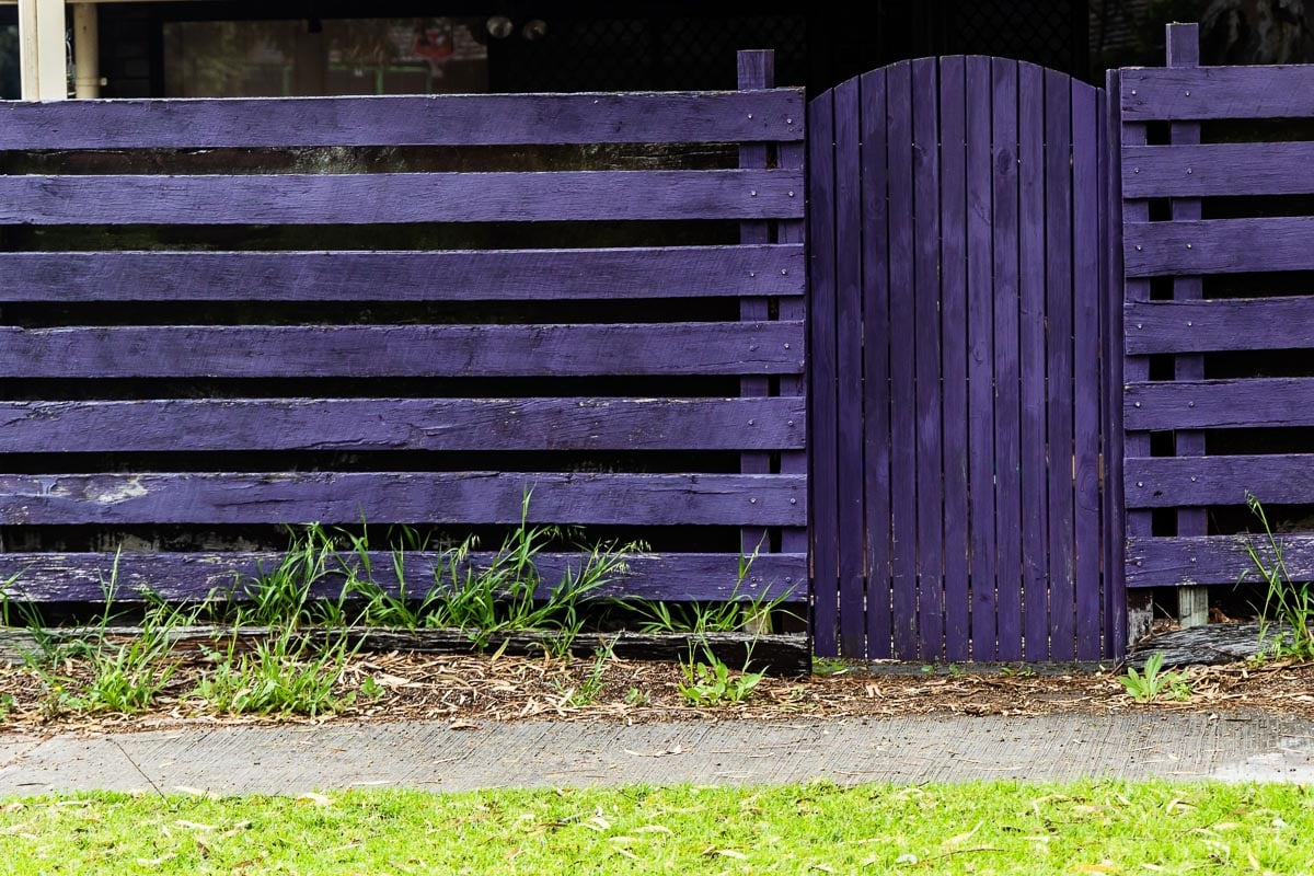 Purple fence with door gate.