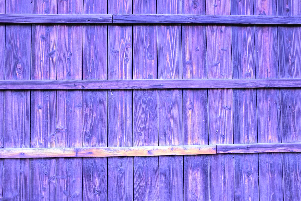 Vivid purple fence with horizontal pieces.