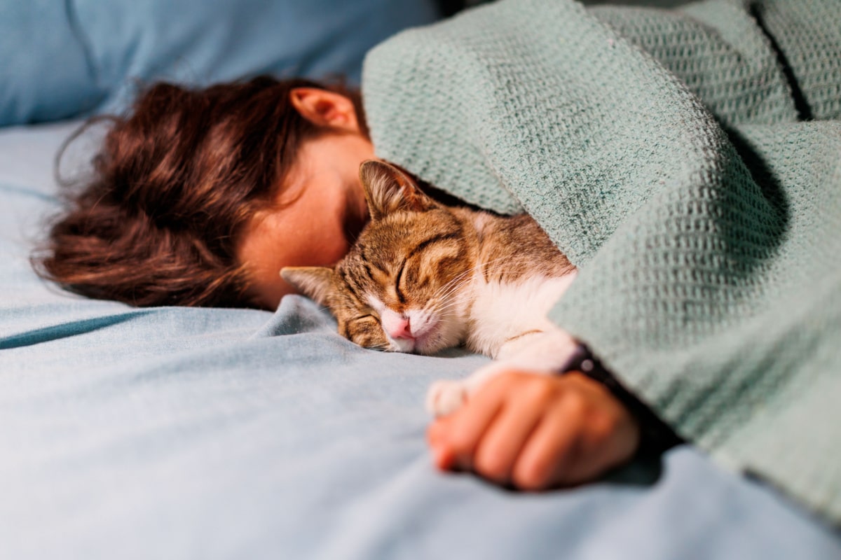 man sleeping with cat.