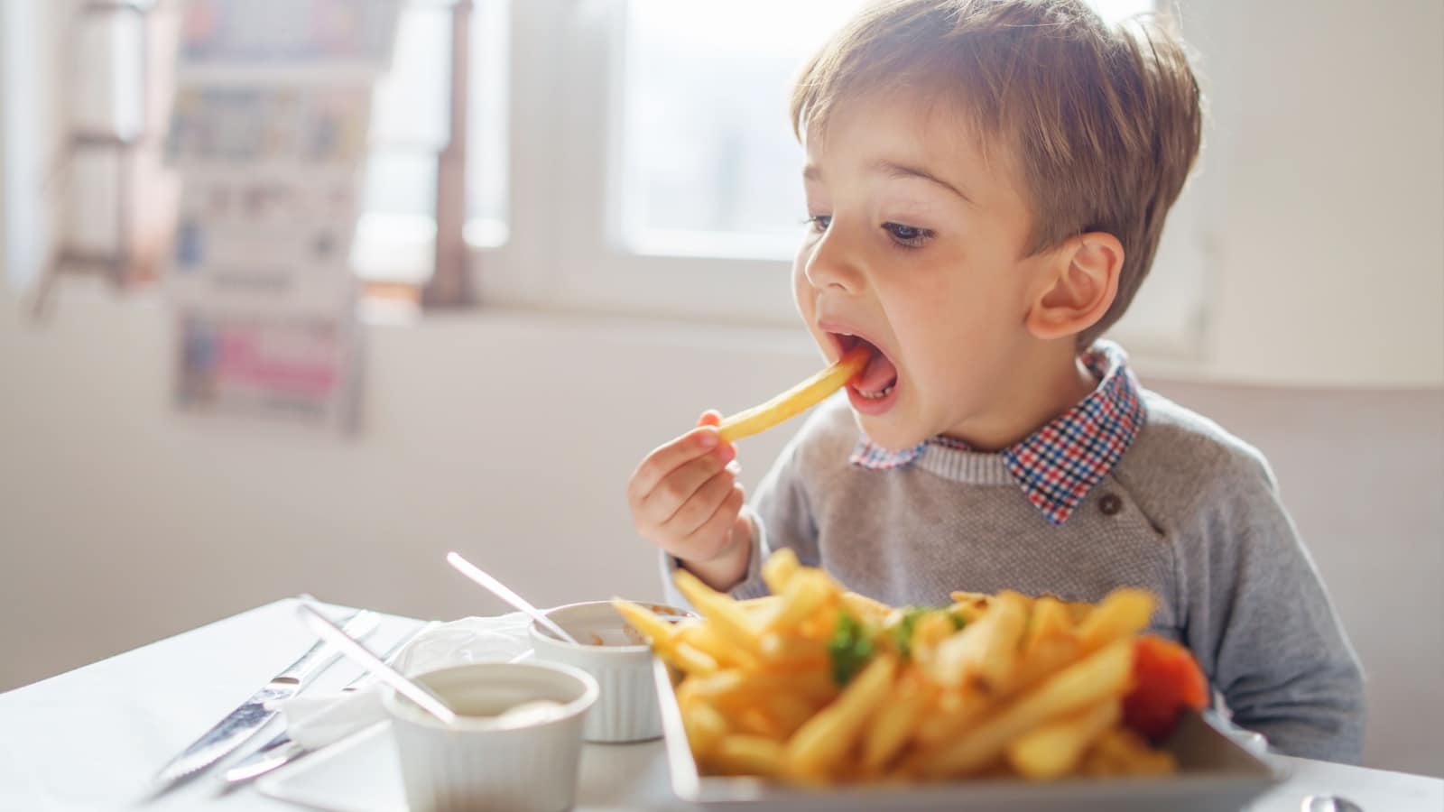 Kid eating fries. 