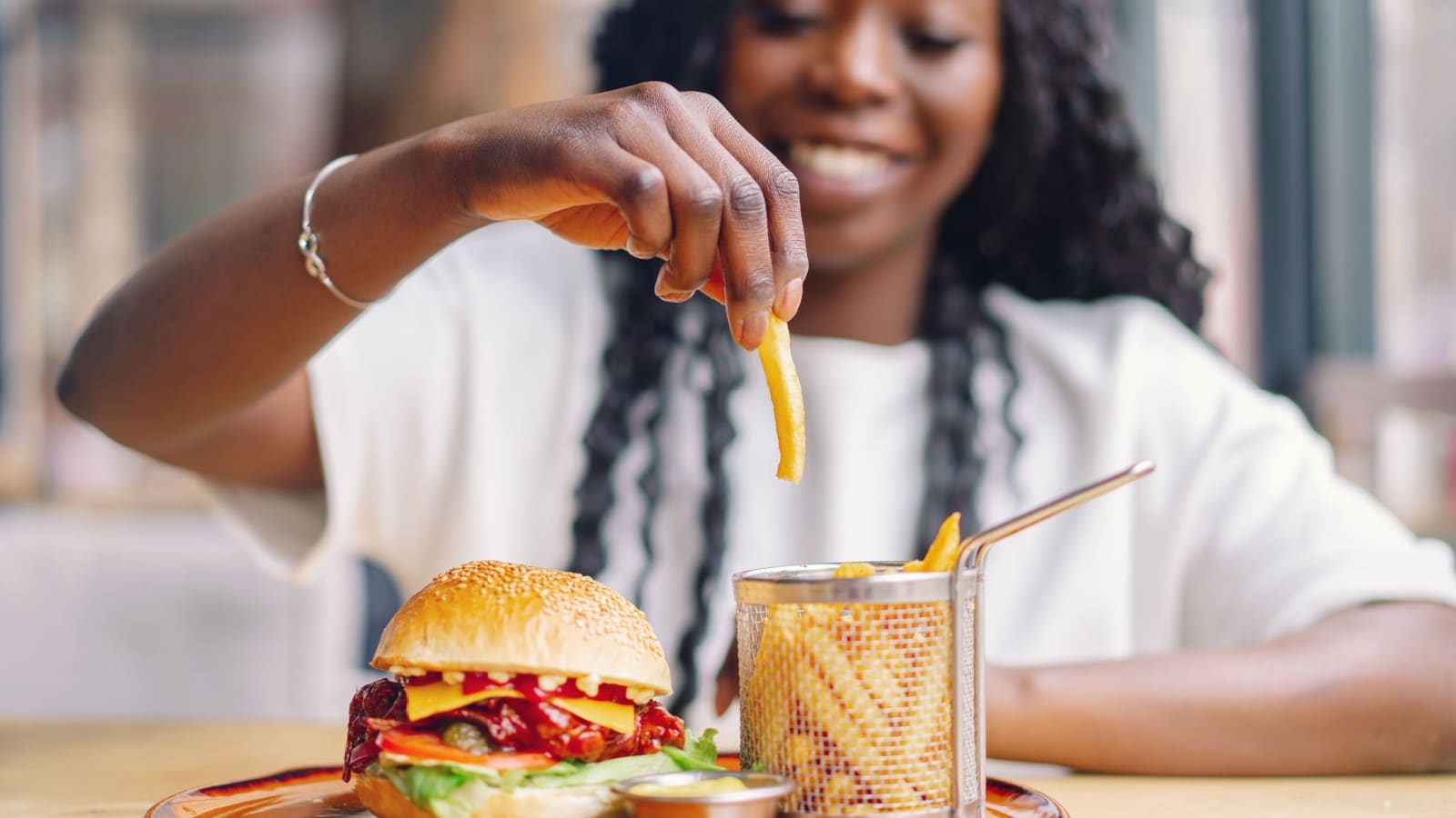 Woman eating fries. 