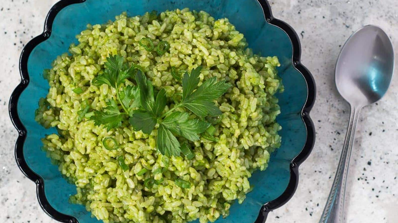 Green-Rice-in-aqua-blue-fluted-glass-bowl-on-grey-quartz-speckled-countertop.