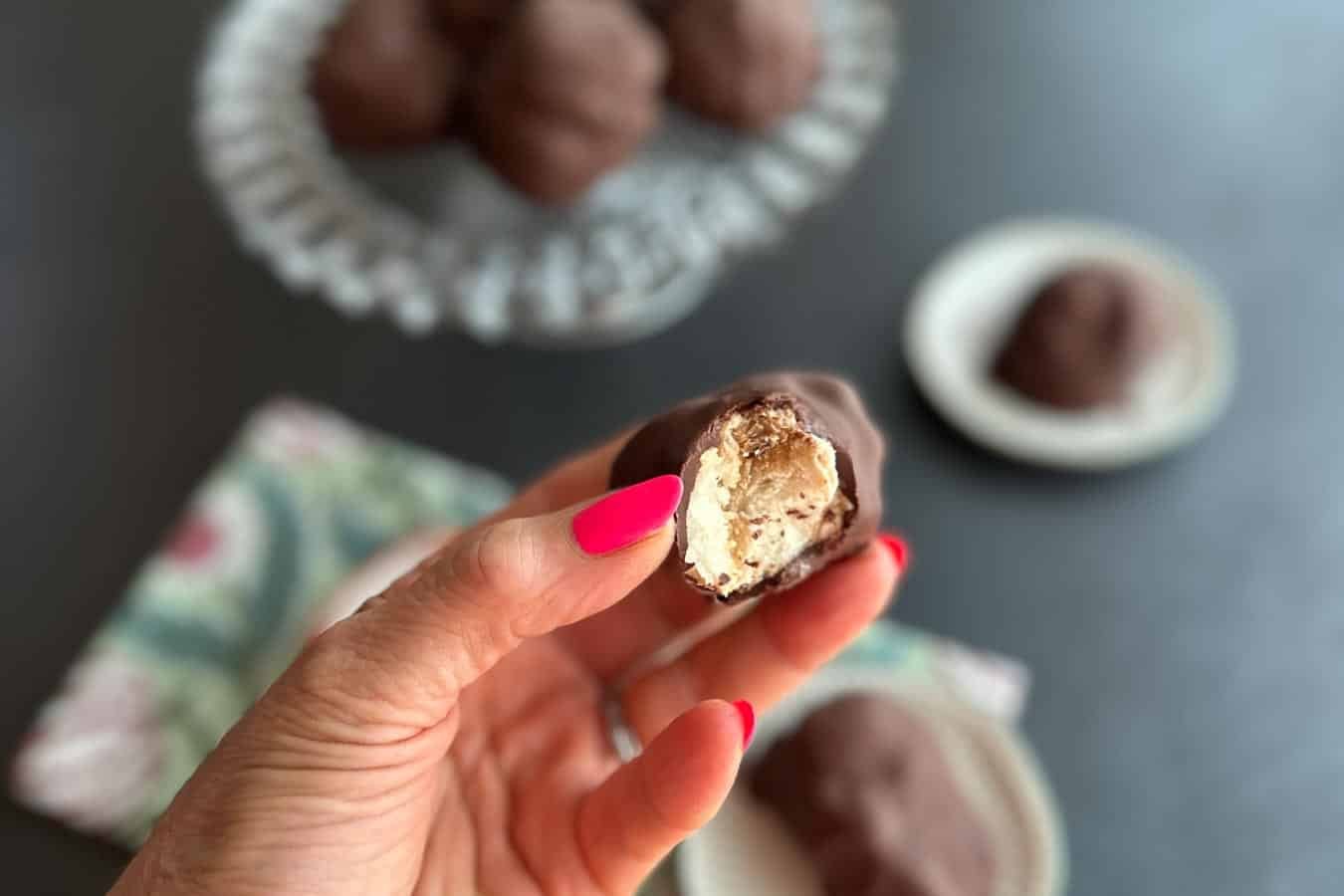 Low FODMAP Frozen Chocolate-Dipped Peanut Butter Banana Bites held in hand.