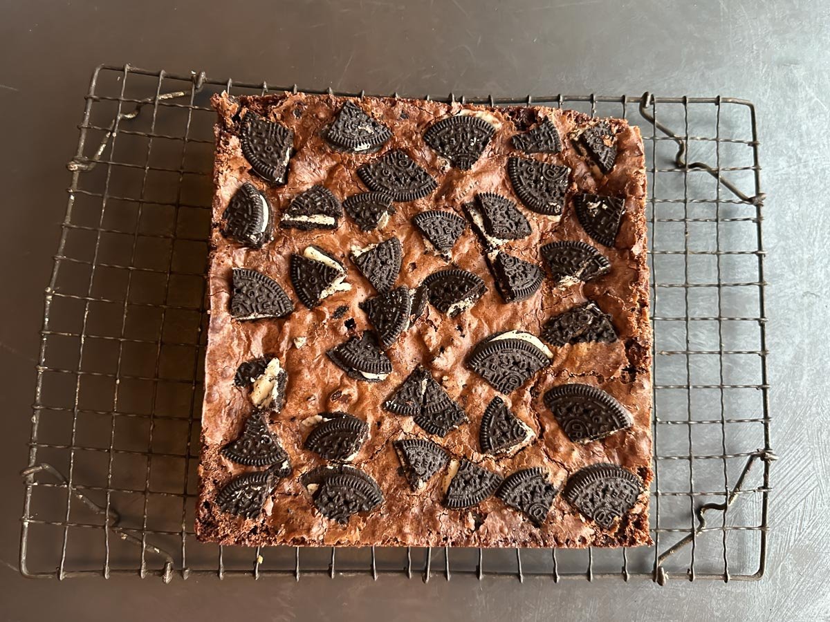 Oreo brownies cooling on rack.