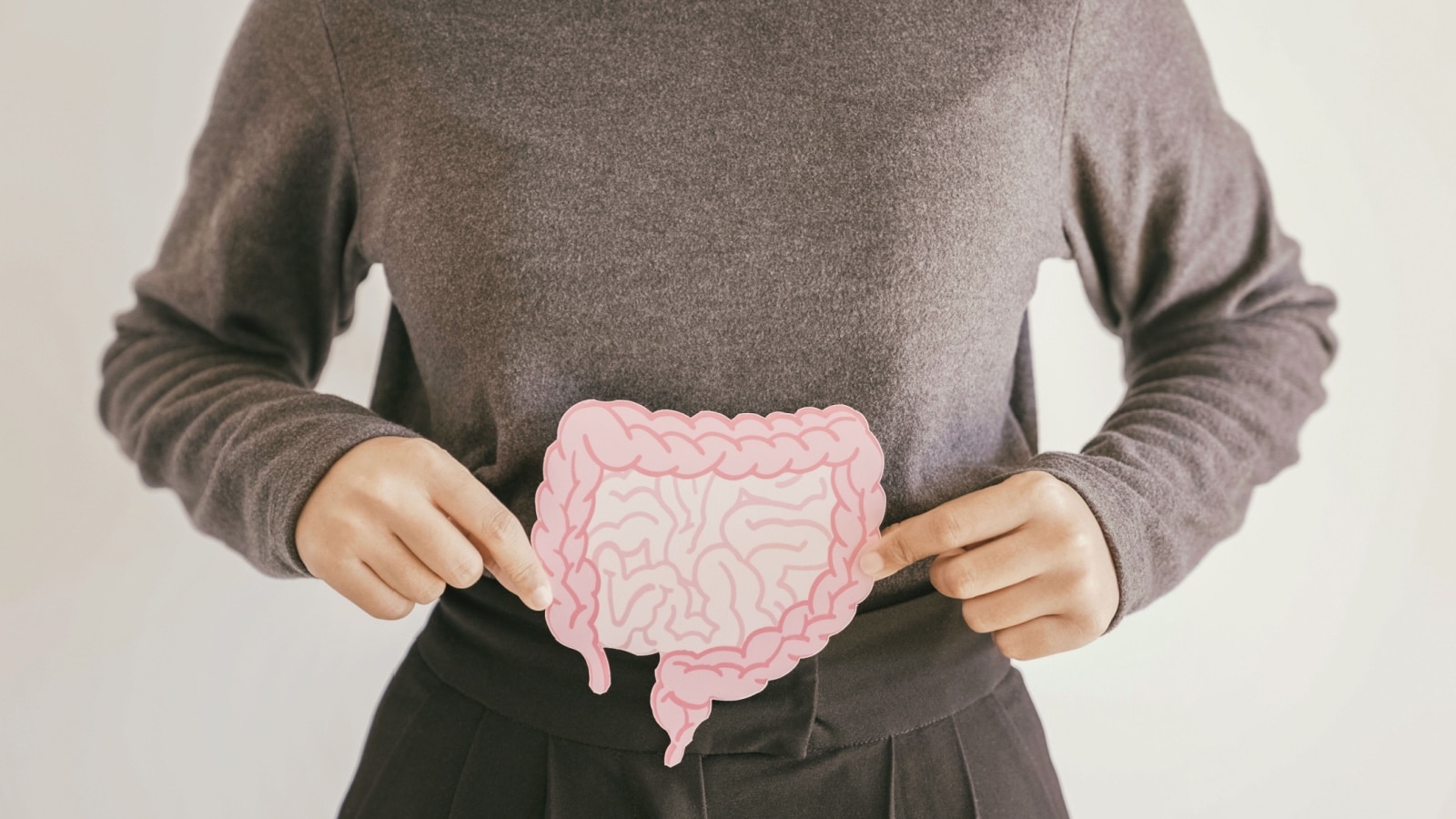 Woman holding cut out of intestines.