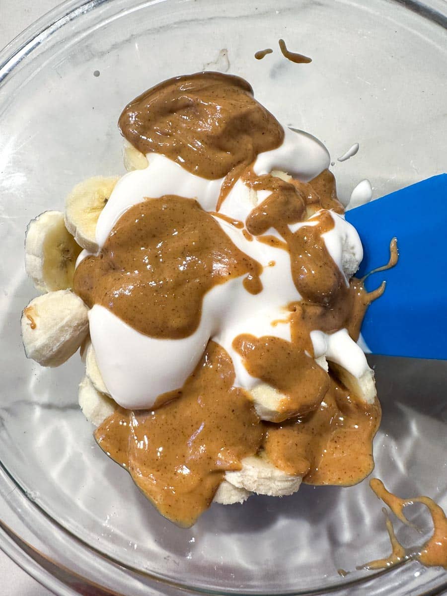 bananas, yogurt and peanut butter in a bowl.