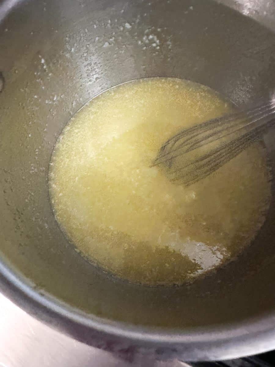 butter, sugar and oil in saucepan melted and combined with whisk.