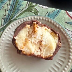 closeup Low FODMAP Frozen Chocolate-Dipped Peanut Butter Banana Bites on small plate.