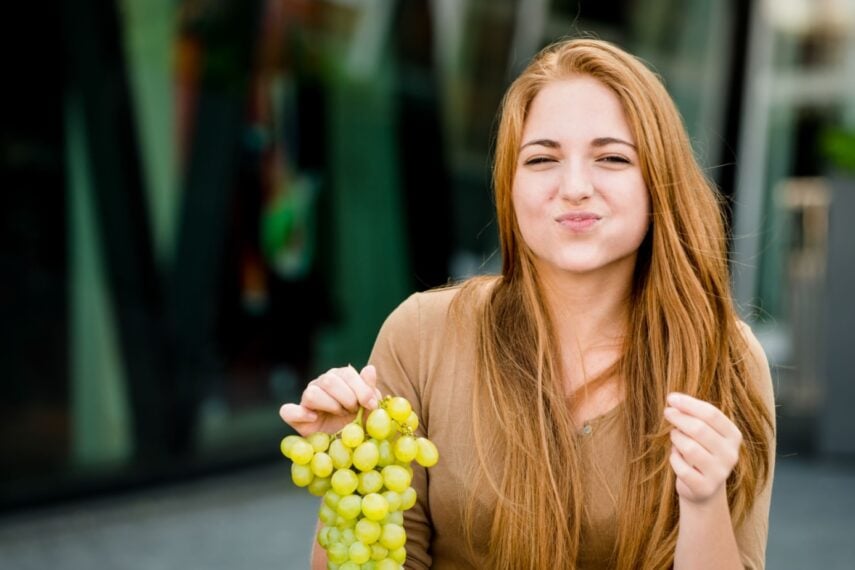 eating grapes.