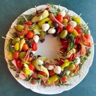 Low FODMAP Antipasto Wreath on dark teal background.