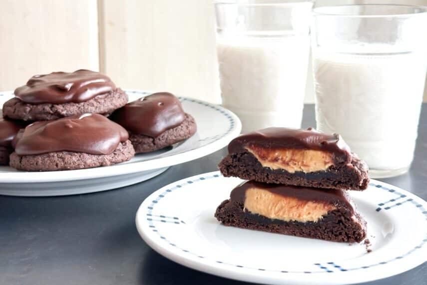 Low FODMAP Peanut Butter Stuffed Chocolate Ganache Cookies on plate with milk.