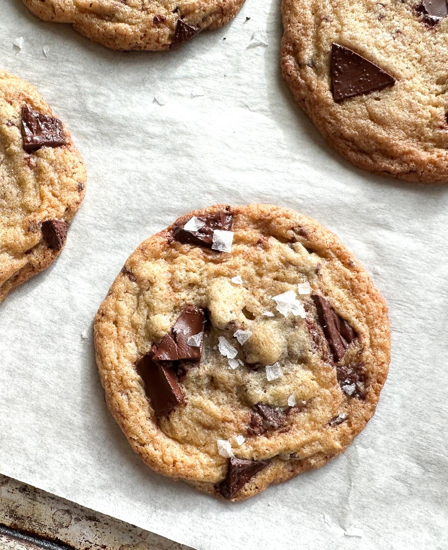 Low FODMAP Tahini Chocolate Chunk Cookies on pan with parchment paper.